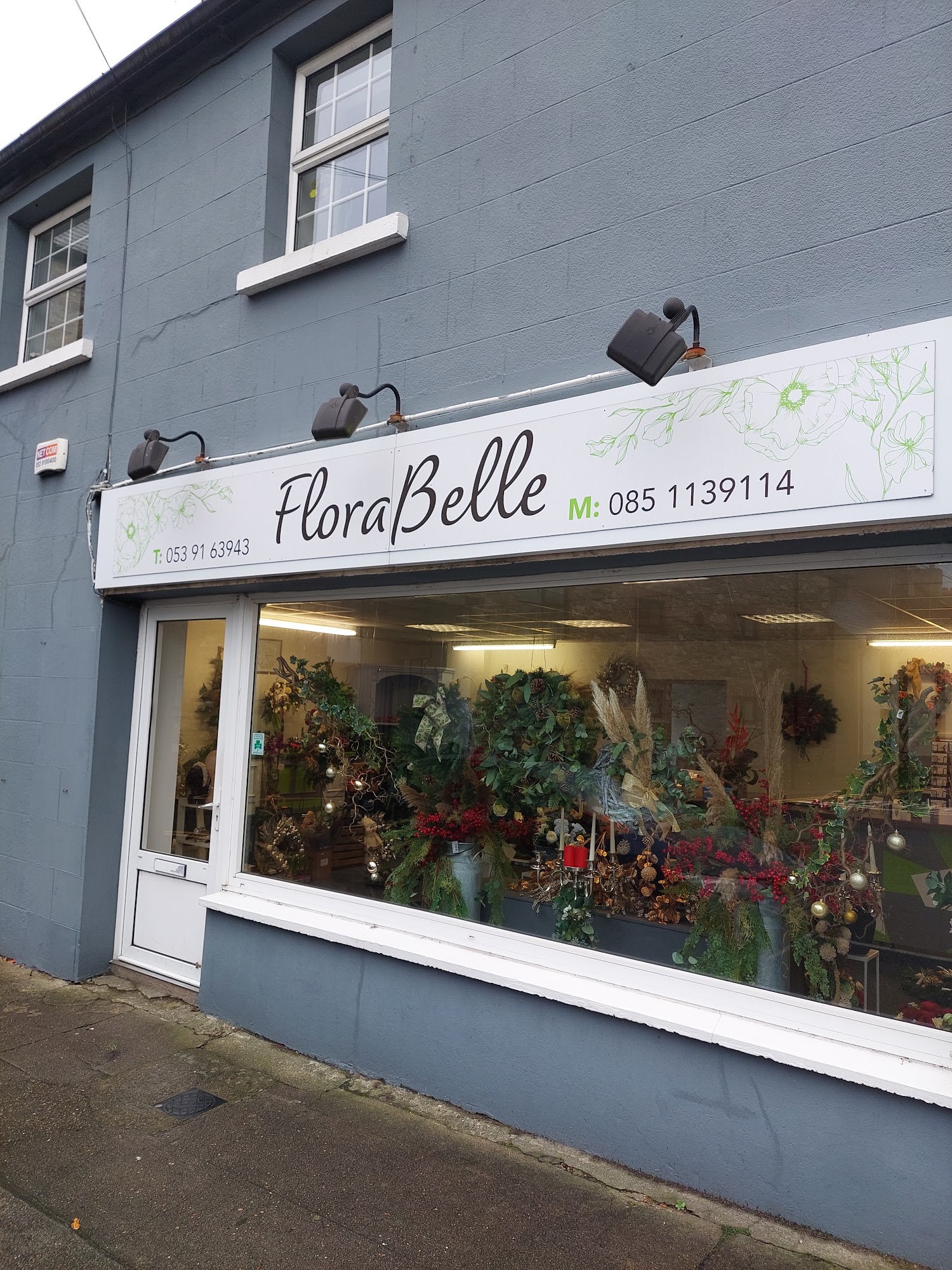 The FloraBelle shopfront on Swan View, The Faythe, Wexford — window filled with flowers and wreaths